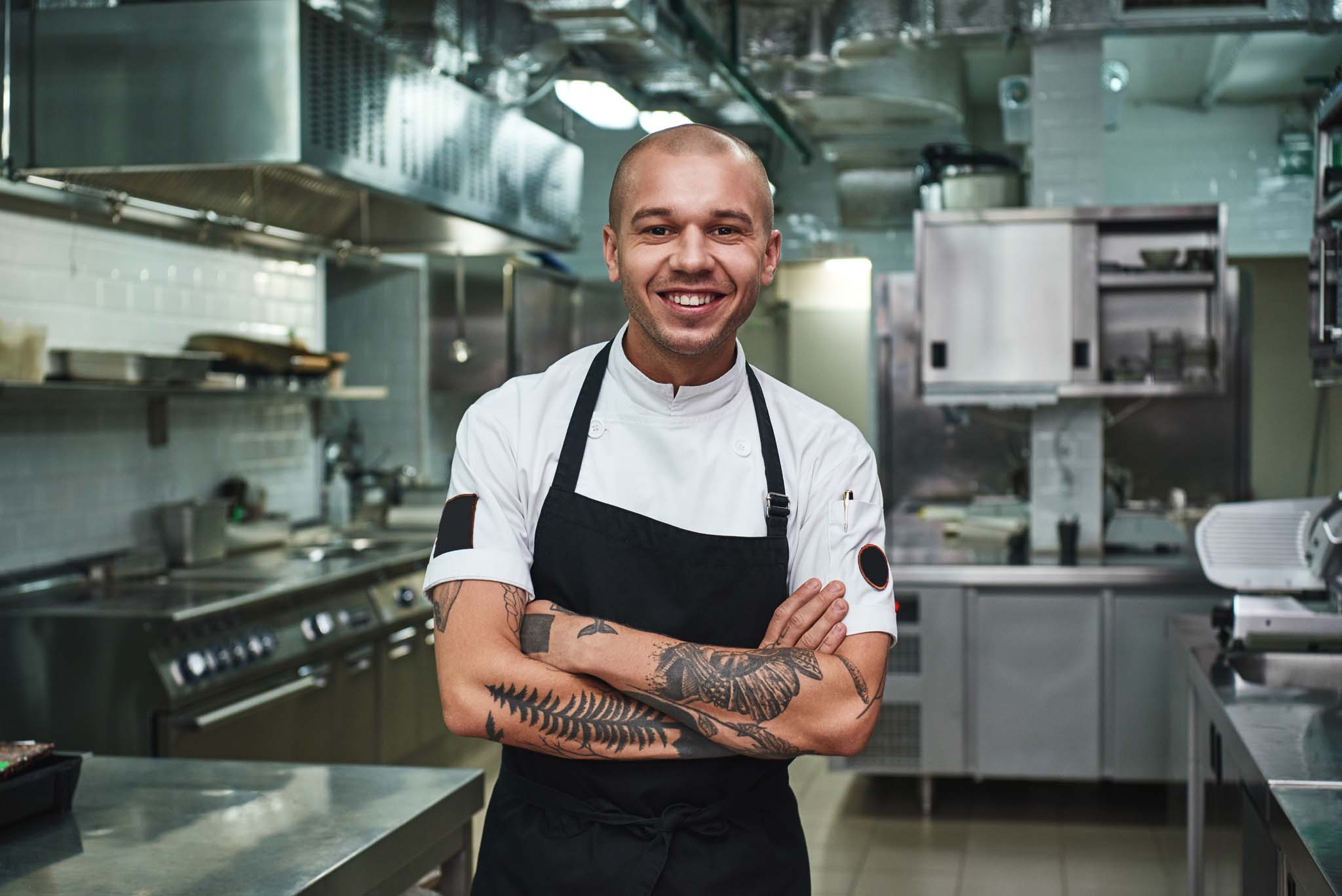 Young chef in apron and smiling