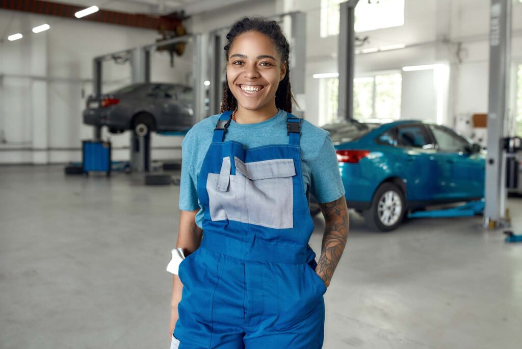 Young professional female mechanic smiling at camera